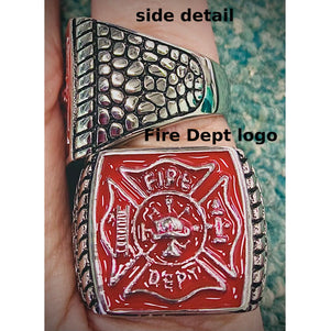 Fire department ring with red emblem and stainless steel details on a hand.